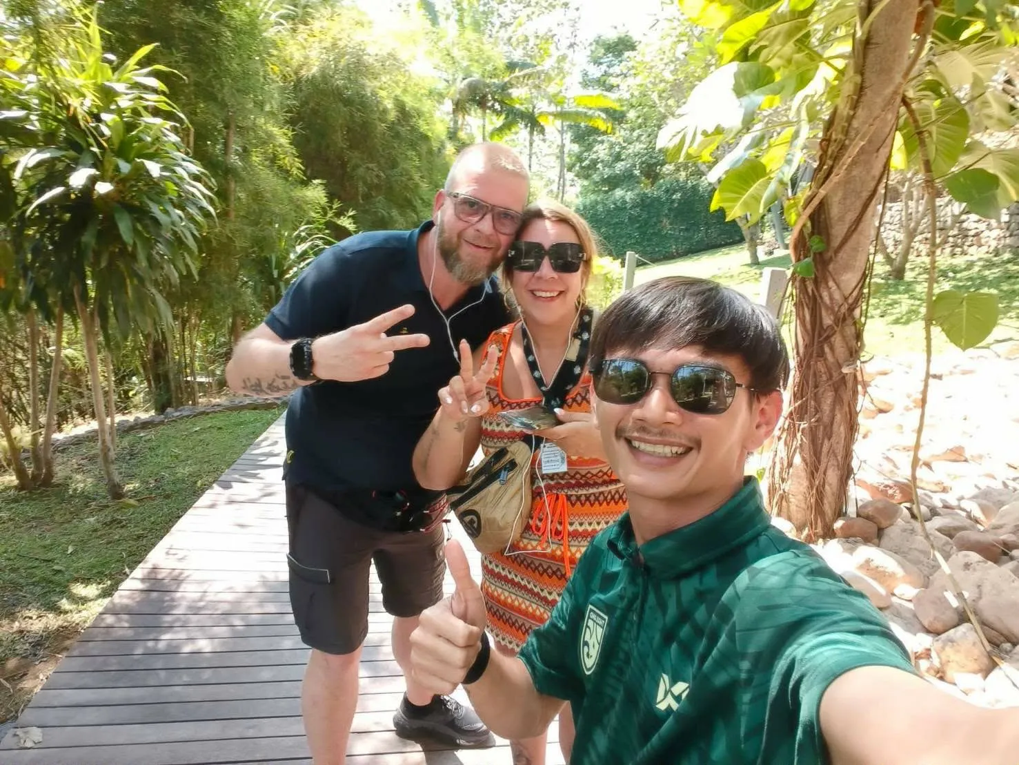 Nong with two guests on a boardwalk in the Kanchanaburi countryside
