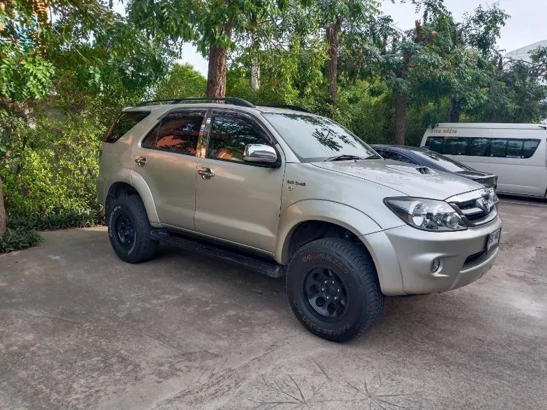 Toyota Fortuner SUV parked under trees